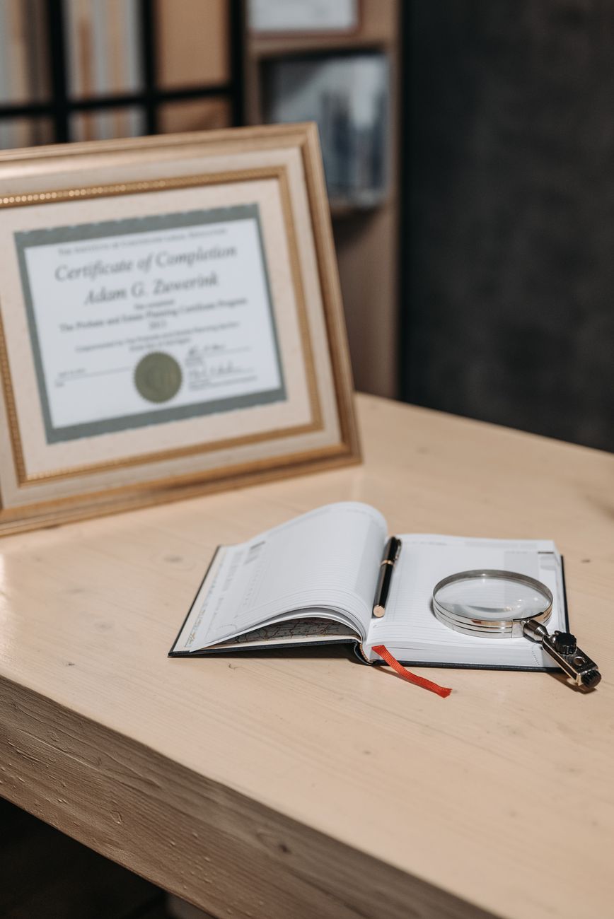 magnifying glass on top of an opened notebook